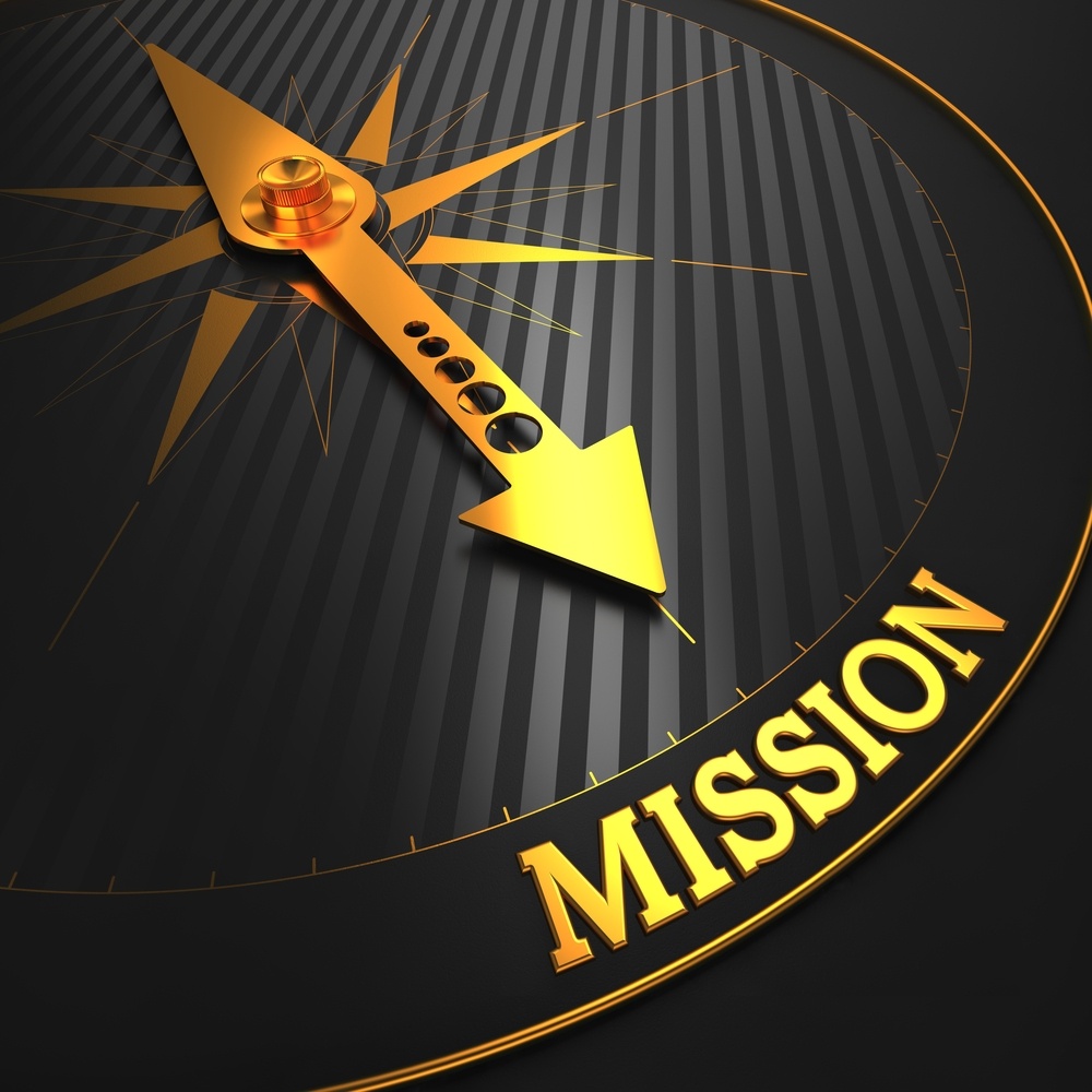 Mission - Business Concept. Golden Compass Needle on a Black Field Pointing to the Word 